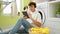 Happy hispanic teen jammin\\\' to tunes on touchpad while waiting for laundry cycle in cozy home\\\'s laundry room