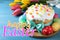 Happy holiday. Easter cake, color eggs and tulips on blue wooden table