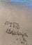 Happy holiday hand written on the sand