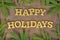 Happy holidays golden text and a spruce branch