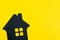 Happy home, good living and lifestyle or buy and sell new house concept, decoration black house shape on solid yellow background