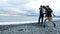 Happy homeless couple, a man and a woman running on the beach