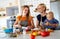 Happy homosexual family with her daughter in kitchen