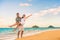 Happy honeymoon couple on beach wedding vacation newlyweds excited in Hawaii travel destination. Husband carrying Asian woman wife