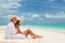 Happy honeymoon vacation at summer. Couple relax on the white sand of beach. Happy sea lifestyle. Young family, man and woman rest