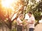 Happy and hopeful caucasian man head touch head of asian young woman couple standing at front yard of new home or relocation after