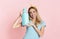 Happy housewife holds fabric softener with empty space