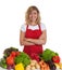 Happy housewife with red apron and fresh vegetables