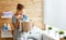 Happy housewife woman in laundry room with washing machine