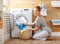 Happy housewife woman in laundry room with washing machine