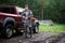 Happy hunter with his son near their pickup truck before hunting in a forest