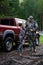 Happy hunter with his son near their pickup truck before hunting in a forest