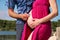 Happy husband is using stethoscope and listening to baby in belly. Closeup of future dad examining pregnant woman with stethoscope