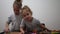 Happy identical twin girls preparing biscuits in the kitchen, casual lifestyle photo in real life interior, christmas cookies