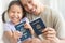 Happy immigrant family becoming new American citizens, holding US passports