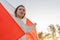 A happy immigrant. Patriotic woman with Canadian flag, portrait in nature in summer