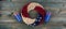 Happy Independence Day with wreath decorated in America national colors and stars plus party cups on rustic faded blue wood