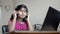 Happy Indian asian caucasian girl wearing headphone enjoying listening music on laptop nodding, dancing and singing song portrait