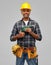 Happy indian builder in helmet with electric drill