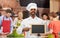 Happy indian chef with chalkboard at cooking class