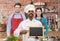 Happy indian chef with chalkboard at cooking class