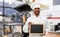 Happy indian chef with chalkboard at kebab shop