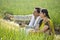 Happy Indian couple farmers examining crop in agricultural field