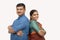 Happy Indian couples in traditional dress with arms crossed standing back to back on isolated background - concept of happy and