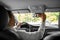 happy indian man or driver adjusting mirror in car