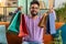 Happy indian man shopaholic consumer came back home after online shopping sale with bags at home