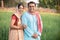 Happy indian rural farmer couple in agricultural field