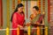 happy Indian Senior mother with daughter placing diya lamps at balcony at home for festival preparation - concept of