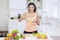 Happy Indian woman eating a bowl of tasty salad