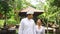 Happy indonesian couple in Bali walk together, talk and smile, hug. Loving sweet