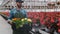 Happy Industrial Greenhouse Worker Carry Boxes Full of Flowers. Smiling and Happy man with flowers he Growing.