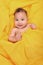 Happy Infant Baby on Yellow Background