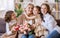 Happy International Womens Day. daughter and granddaughter giving flowers to grandmother celebrate Mother's Day