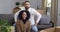 Happy interracial couple afro american woman and caucasian man homeowners sitting together on couch surrounded by boxes