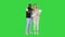 Happy interracial couple holding their baby on a Green Screen, Chroma Key.