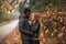 Happy Interracial couple posing in blurry autumn park background