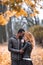 Happy Interracial couple posing in blurry autumn park background