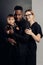 Happy interracial family with baby daughter poses in studio