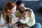 happy interracial parents playing with baby