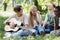 Happy interracial teenagers sitting on grass