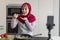 Happy Islamic Woman In Hijab Recording Video While Cooking