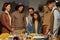 Happy Jewish family of three generations looking at burning menorah candles