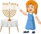 Happy jewish girl lights hanukkah candles