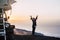 Happy joy people travel with car and tent roof in wild places enjoying the sunset on the top of a mountain - travel and freedom