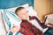 Happy joyful child 8 years old schoolboy lies on bed with mobile phone in his hands, education game social media concept