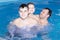 A Happy joyful family swims in the pool, water